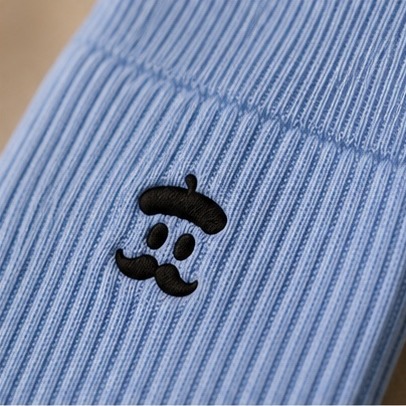 Macro close-up of the ribbed cotton knit and embroidered Sockrebleu logo